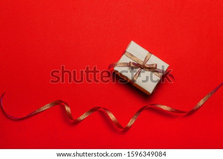 Greeting card template with beautiful red gift box, ribbons on red background. Valentine's day, Mother's Day, Father's Day, Birthday festive background