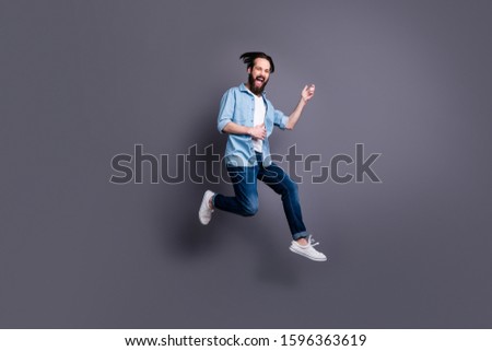 Full size photo of crazy funky heavy metal guy jump play guitar perform stage loud sound musci scream wear stylish clothes isolated over grey color background Royalty-Free Stock Photo #1596363619