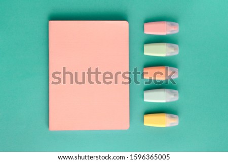 Pastel school supplies, notebook and markers on mint paper background. Top view, flat lay, frome above. Back to school. Royalty-Free Stock Photo #1596365005