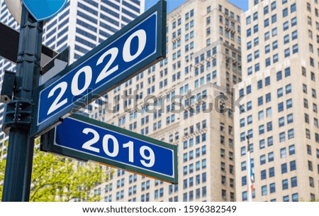 2020 new year and year 2019 Streets signs crossroad, blue color. Highrise buildings  background