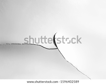 Cracking and peeling of interior paint, in the form of cracking from the cement wall. Use as an abstract background.