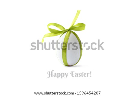 Сreative photo with easter egg and green ribbon.