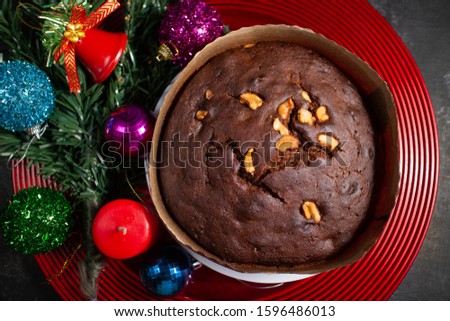 Plum cake made with dried fruit, raisins, cashew nuts, almond etc. Tasty home made cake flavored with cinnamon and spices for sale on Christmas and new year Kerala India.
