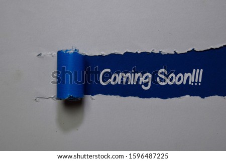 Coming Soon! write on blue and white torn paper