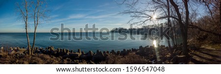A panorama photo of the Cleveland (Ohio) skyline on a hazy winter morning over the shores of Lake Erie taken from Lakewood Park, Ohio.