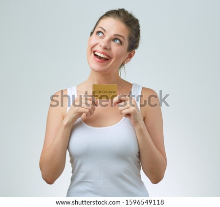 Smiling woman in white singlet top holding card and looking up. Sport Training abonnement concept with female portrait.