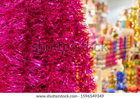 Photo of decoration from decorative multi-colored tinsel for the New Year and Christmas. Bright lights and colors, festive mood. The concept of a happy meeting of Christmas and New Year.