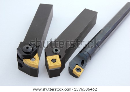 Coated carbide cutting tools for lathe use. Royalty-Free Stock Photo #1596586462