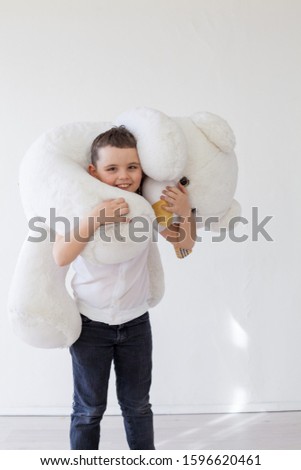 Little boy with big soft bear toy