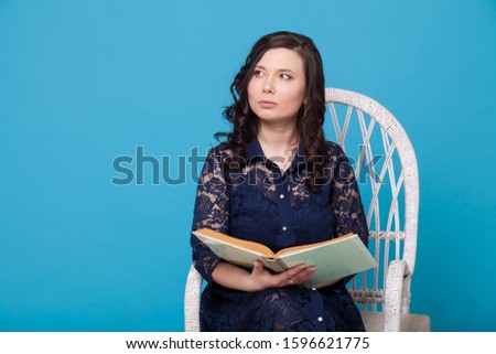 portrait of a beautiful fashionable Asian woman with a teaching book