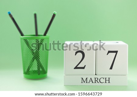 Desk calendar of two cubes for March 27