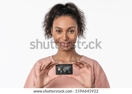 Close up portrait of young african happy woman posing isolated over white background holding credit card