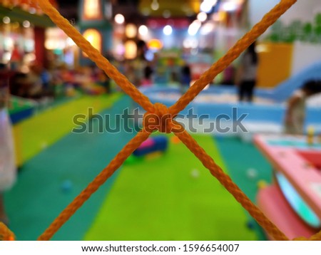 Orange nylon rope on the playground background blur