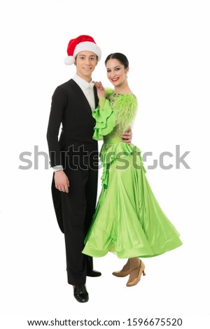 winter waltz. happy couple of dancers celebrate xmas. tuxedo man in santa hat hug his girl partner. ballroom dancing couple isolated on white. best show for corporate party. formal event on christmas.