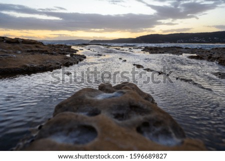 Soft focus of a rock with moving water