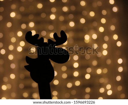 Christmas deer on bokeh background of garlands