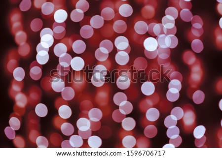 Abstract Christmas and New Year background with blur bokeh effect, holiday backdrop. Glitter rainbow Christmas festive lights