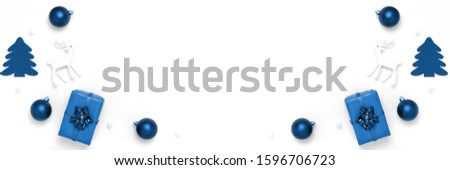 New Year and Christmas composition. Frame from blue balls, white stars, chrismas tree, deer on white paper background. Top view, flat lay, copy space. Trendy color of the year 2020. Banner Royalty-Free Stock Photo #1596706723