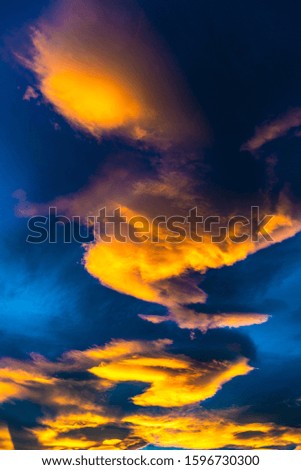 Red clouds on blue sky background in sunset time