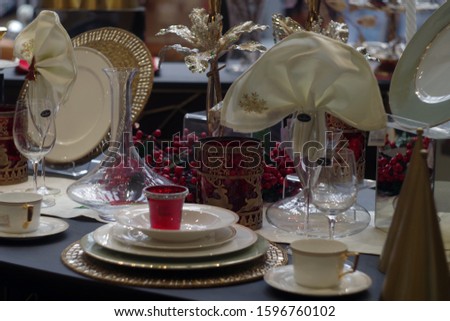 Table with dishes and Christmas decoration.