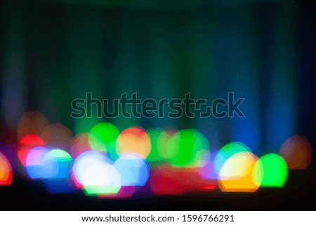 Abstract unfocused background - colorful bokeh of different bubbles on a background. Modern blurred pattern for design and for Christmas, New year and funny holiday backdrops.
