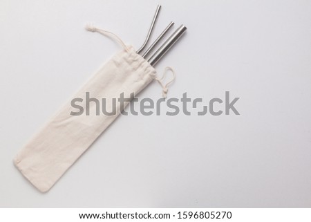 Bag of metallic straws at the side Royalty-Free Stock Photo #1596805270