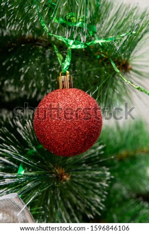 Round red christmas balls on christmas tree.