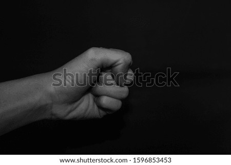 Monochrome hand gestures on black background