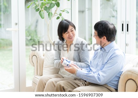 Asian middle-aged couple in the living room