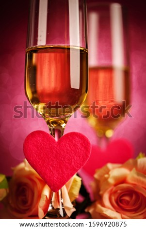 Champagne glasses on a beautiful bokeh background. Valentine's day. Background with copy space. Selective focus. Vertical.