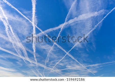 Contrails over blue sky. Royalty-Free Stock Photo #159692186