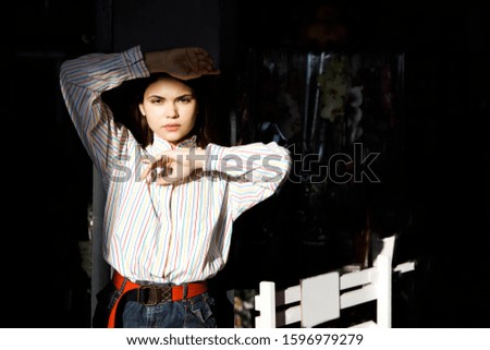 Pretty young brunette girl posing to photographer in store