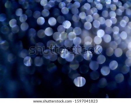 close-up of decorative abstract window surface after rain with blur / bokeh effect in classic blue color