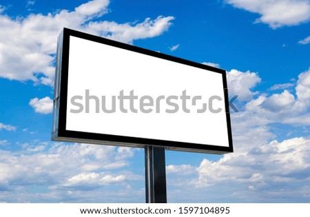 Blank billboard mockup with white screen against clouds and blue sky background.  