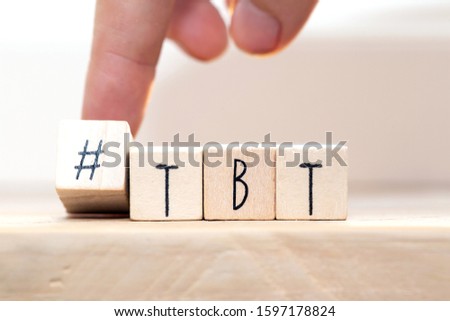 Wooden cubes with Hashtag tbt, meaning Throwback Thursday near white background social media concept close-up