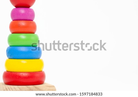 Wooden toys are red, green, yellow, and blue. Many numbers arranged beautifully. Red round wood Captured by hand. isolated a white background.Copy space.