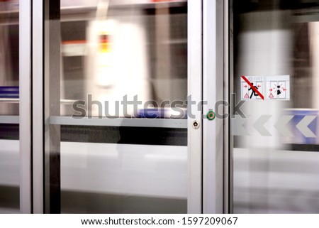 speedy subway grey with white signe beware of the doors 