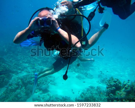 Man scuba diver and beautiful colorful coral reef underwater.