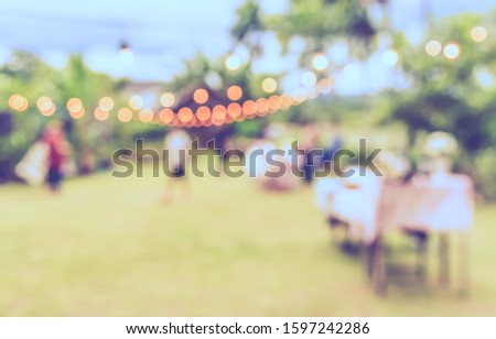 Vintage tone abstract blur image of people in  banqueting outdoor party with bokeh for background usage .