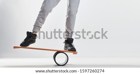 Women on Deck for balance board. Rocker-roller boards. Isolated oval wooden deck for balance board. solid plastic roller for balance board. Rocker-roller boards. Isolated