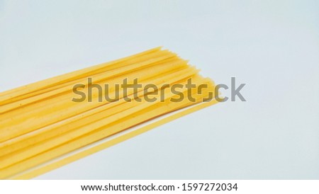 uncooked spaghetti placed on side of pictures