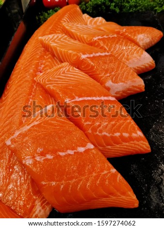 Fresh colorful raw salmon fish fillets in the supermarket for cooking.