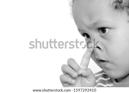 boy picking his nose on white background stock photo