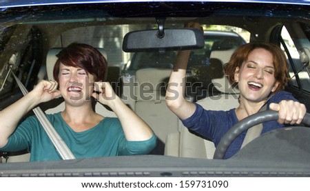 annoyed passenger and singing female driver Royalty-Free Stock Photo #159731090