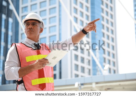 Close up engineers working on a building site . Engineering and architecture concept