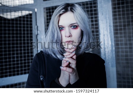 Dark gothic blonde girl with red eyeshadow