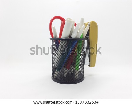 Various Writing Drawing Art and Working Business Appliances on Desktop Table in Black Mesh Tube Shape Case Packaging Container in White Isolated Background
