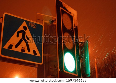 Road sign pedestrian and traffic light crossing completely hidden by snow.