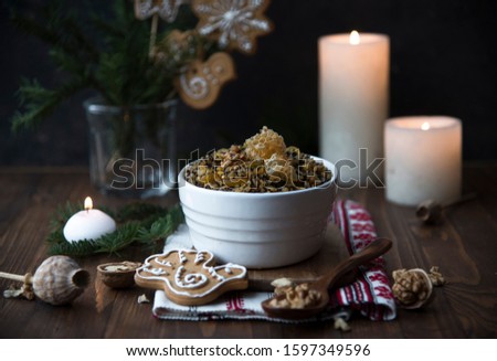 kutya, rushnyk, candles and christmas decor on a wooden table. Christmas Slovenian food
