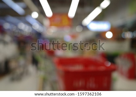 Abstract blurred image of people in supermarket for background usage.Modern supermarket interior, abstract blur background